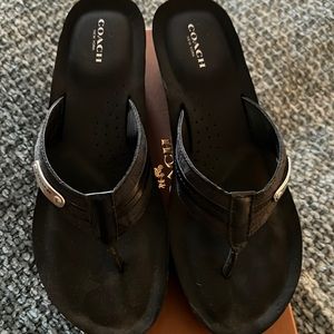 Black summer sandals by coach.